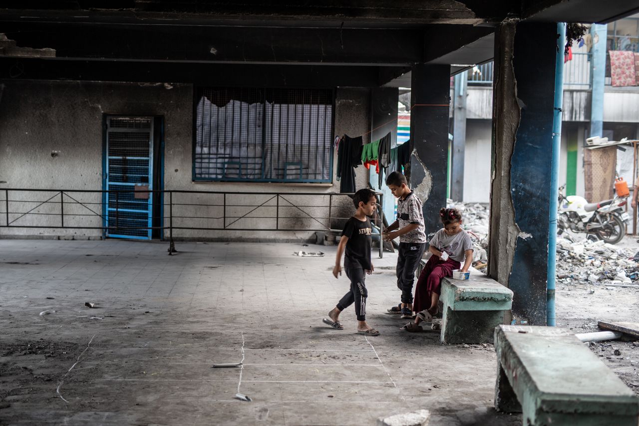 Palestinian children seeking shelter in a school destroyed in an Israeli attack