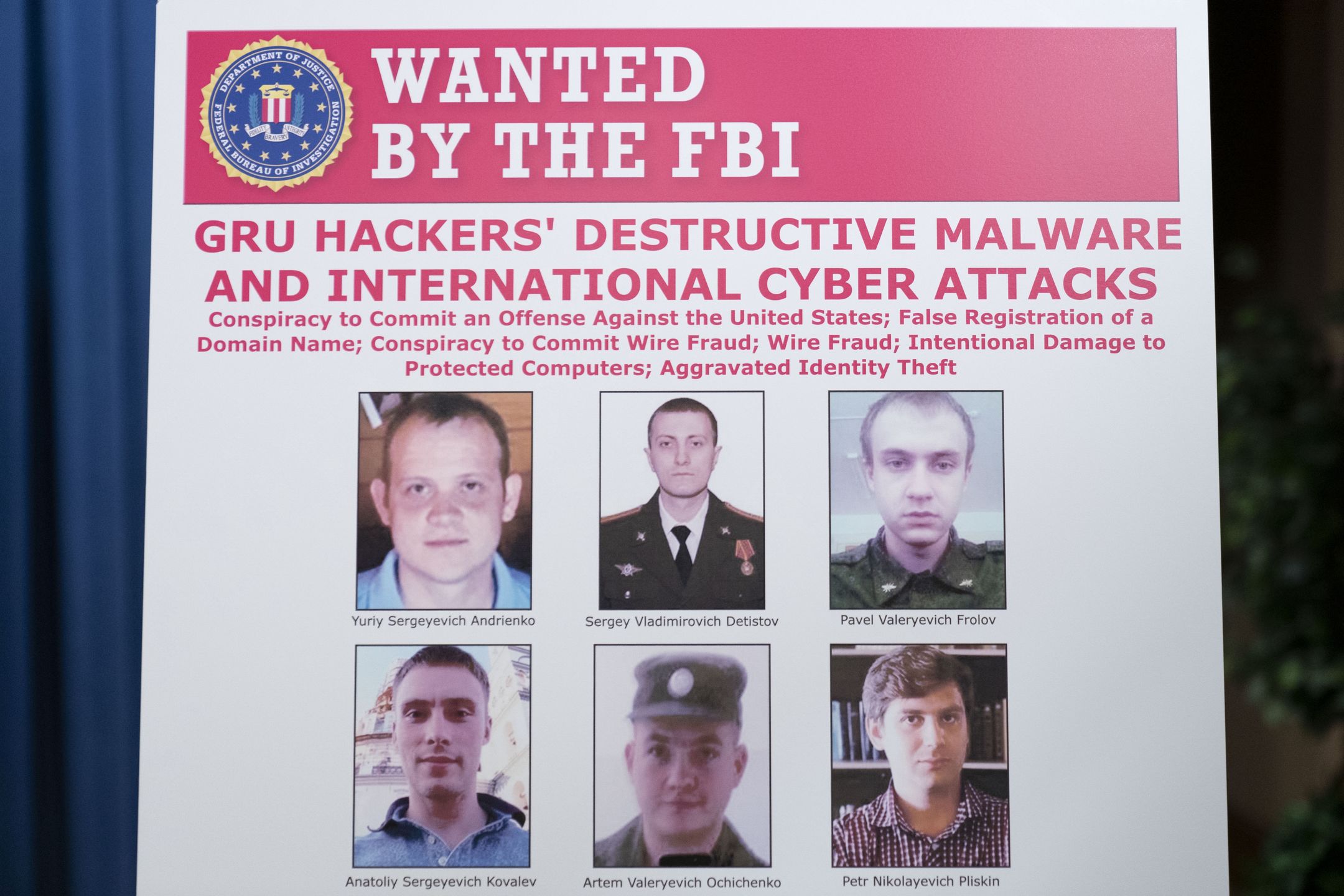 WASHINGTON, DC - OCTOBER 19:  A poster showing six wanted Russian military intelligence officers is displayed before a news conference at the Department of Justice, on October 19, 2020 in Washington, DC. The Justice Department announced an indictment against six Russia GRU officers charged with engaging in a series of hacking and malware deployment operations to attack other countries' infrastructure, elections and other actions designed to further Russia's interests. (Photo by Andrew Harnik - Pool/Getty Images)