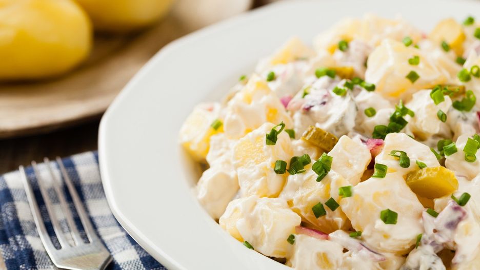 Traditional German potato salad with cucumber, onion and mayonnaise.