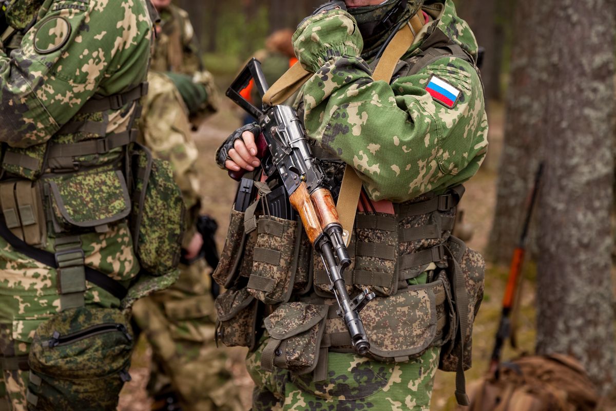 Rosyjski żołnierz trzymający karabin maszynowy na wojnie