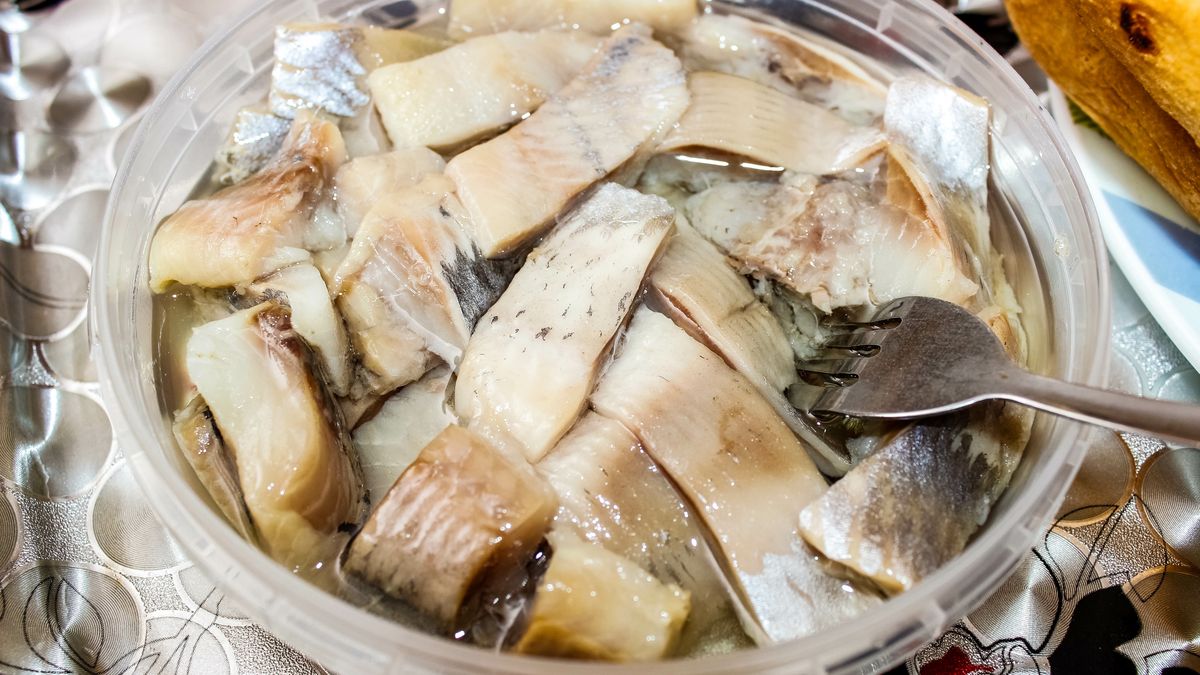 Sliced herring in oil, which is in a plastic jar with a fork.
Sliced herring in oil, which is in a plastic jar with a fork. Close-up, selective shot.
herring, fish, fork, food, oil, salted, canned, jar, sprat, white, slice, pickled, sardine, cuisine, mackerel, seafood, onion, dish, wooden, cooking, red, greens, healthy, table, sea, fillet, nutrition, lunch, macro, serving, preserves, dinner, horizontal, delicious, kitchen, capelin, black, background, canned food, delicacy, piece, ingredient, snack, traditional, close-up, close, impaled, strung, nordic, fresh