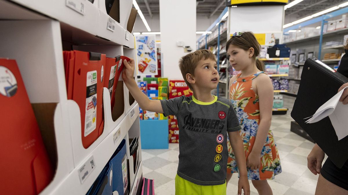 Bruno Sebastian, left, and Ophelia Sebastian shop for back-to-school supplies with their mother, Nicole, right, before starting the first and fourth grades, respectively, on July 25, 2022, at an OfficeMax in Lincoln Park. (Brian Cassella/Chicago Tribune/Tribune News Service via Getty Images)