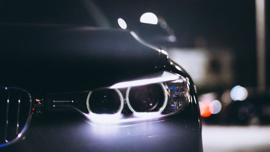 Front car lights at night on the road