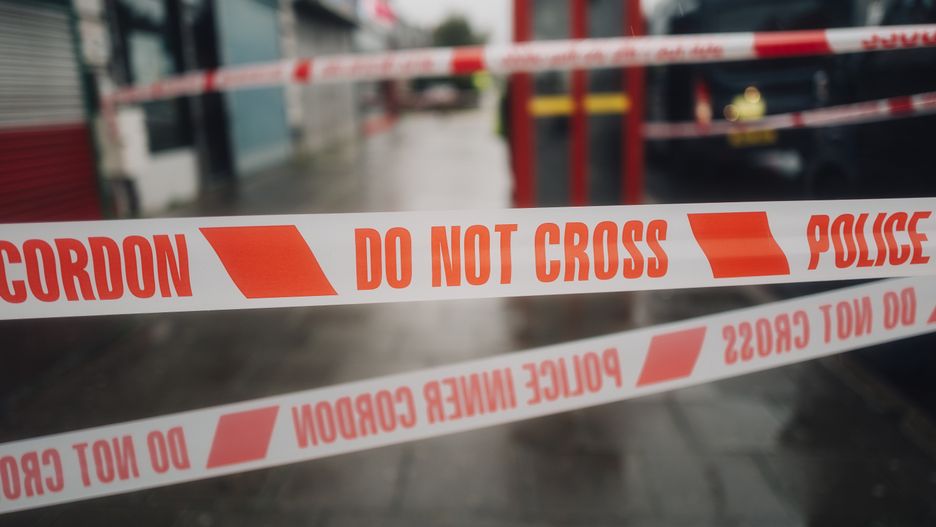 Police white and red cordon tape separating the crime scene.
Photo of the white and red police cordon tape saying Do Not Cross, in the place of the crime scene.
Mykola  Romanovskyy