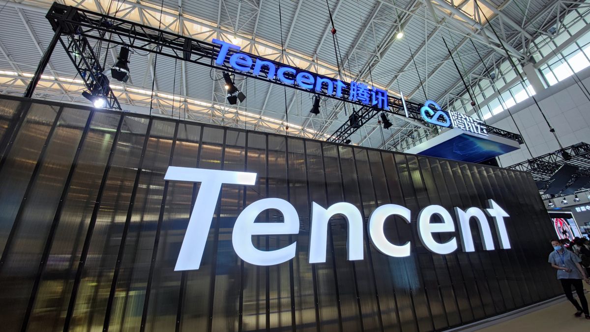TIANJIN, CHINA - MAY 20: A man walks by logos of Tencent and Tencent Cloud during 5th World Intelligence Congress (WIC) at Tianjin Meijiang Conference and Exhibition Center on May 20, 2021 in Tianjin, China. (Photo by VCG/VCG via Getty Images)