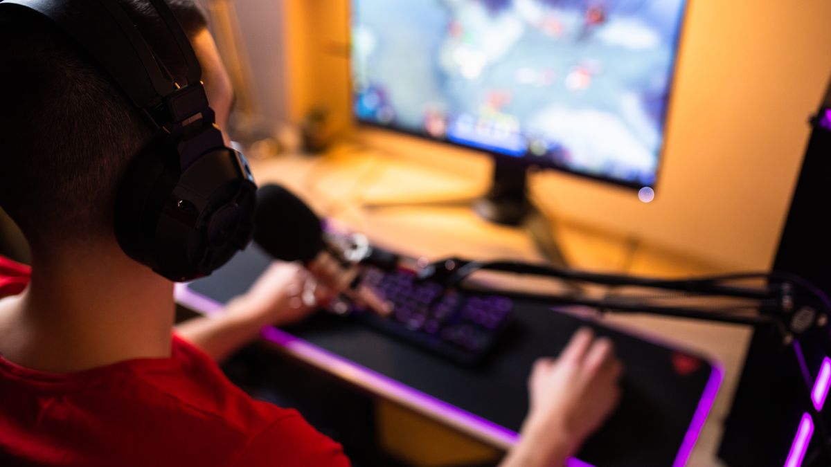 A young gamer is playing an online multiplayer game at his home