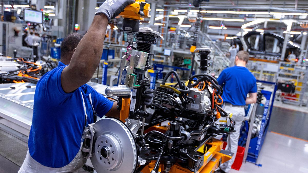 An employee assembles the chassis of a Volkswagen AG (VW) ID.3 electric vehicle (EV) on the assembly line at the automaker's electric automobile plant in Zwickau, Germany, on Tuesday, April 26, 2022. The Zwickau assembly lines are the centerpiece of a plan by VW, the world's biggest automaker, to manufacture as many as 330,000 cars annually. Photographer: Krisztian Bocsi/Bloomberg via Getty Images