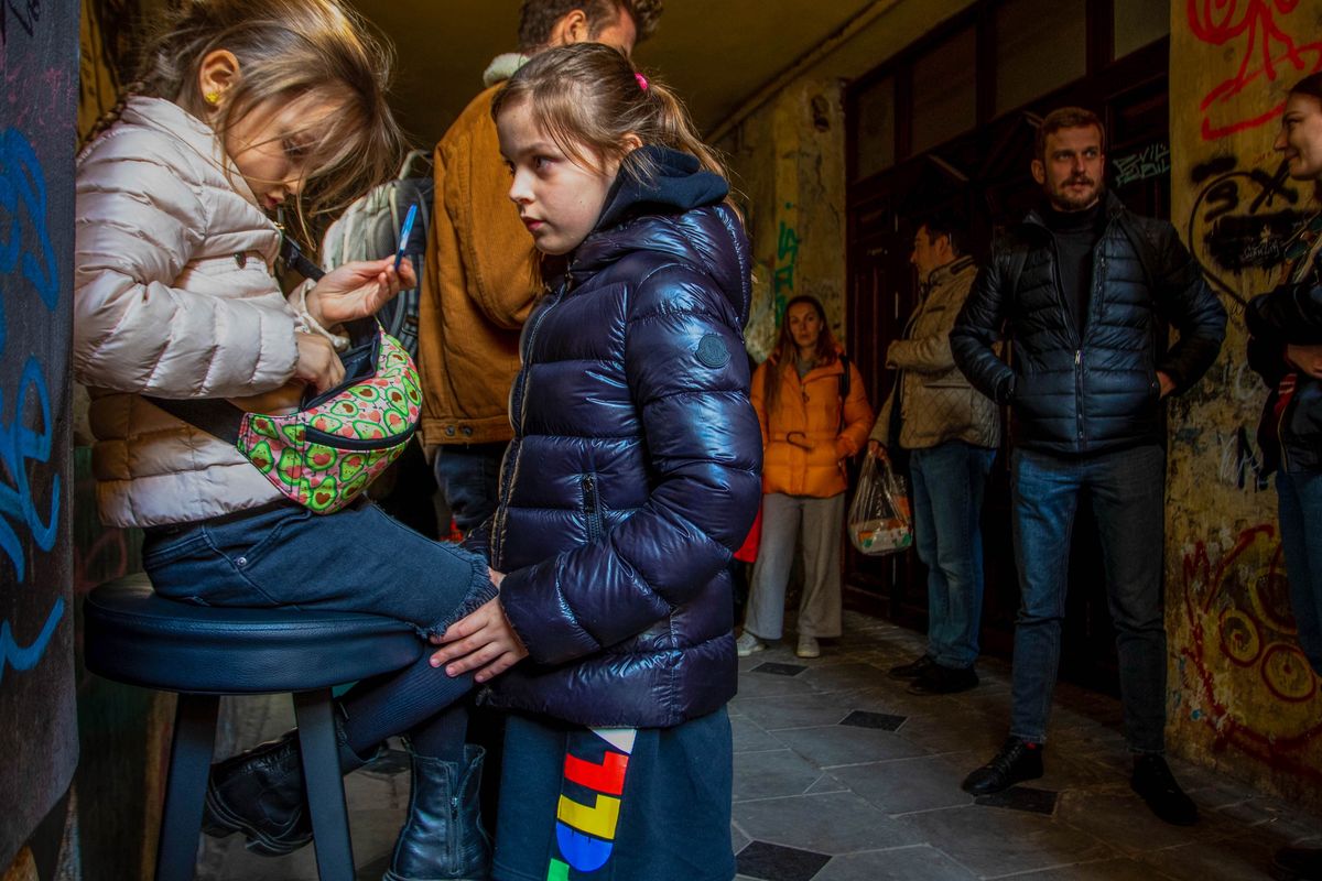 LVIV, UKRAINE - 2022/03/25: Kids wait in a sheltered area during an air raid alert. People take cover as air raid sirens ring over the city of Lviv. (Photo by Ty O'Neil/SOPA Images/LightRocket via Getty Images)