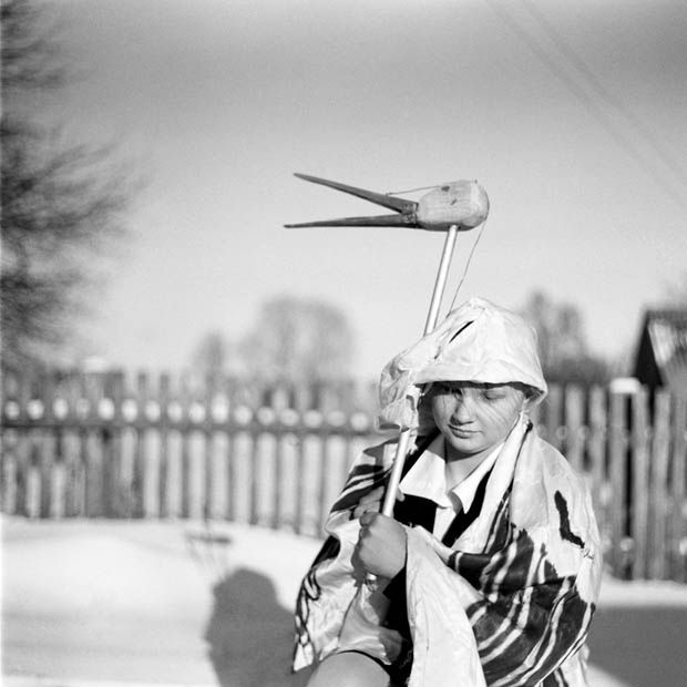 Belarus  / Pagost / 10.01. 2009 /A girl in stork's costume posses   during the traditional Koliadki holiday in the Belarus village of Pagost, (300 km from Minsk), on Saturday, 10 January 2009. Koliadki refers to many of the pre-Soviet Era Christmas traditions. Fancy dressed people go from house to house, singing, dancing, eating and drinking. The hosts will give money or food to their guests as a sign for them to leave the house.Â© Andrei Liankevich / Anzenberger