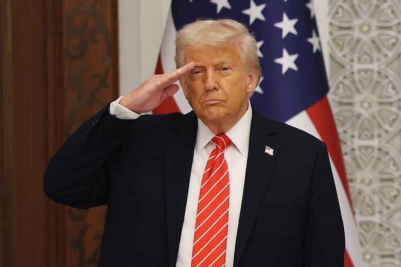 DOHA, QATAR - MAY 14: US President Donald Trump stands and salutes during the playing of the national anthem of the United States while attending a state dinner at the Lusail Palace on May 14, 2025, in Doha, Qatar. The visit underscores the strategic partnership between the United States and Qatar, focusing on regional security and economic collaboration.  (Photo by Win McNamee/Getty Images)