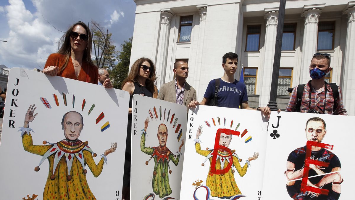 KIEV, UKRAINE - 2020/07/21: Activists hold symbolic large playing cards depicting president of Russia, Vladimir Putin and pro-Russian separatist, Pavel Gubarev as they take part in a performance rally 'Putin's house of cards', outside the Verkhovna Rada (Ukrainian Parliament).The performance was held by former Ukrainian prisoners of the eastern Ukraine war conflict, relatives, human rights activists and artists like Donetsk artist, Serhiy Zakharov, to draw attention of lawmakers to the problem of impunity for war crimes. The activists protest against Russian authorities. (Photo by Pavlo Conchar/SOPA Images/LightRocket via Getty Images)