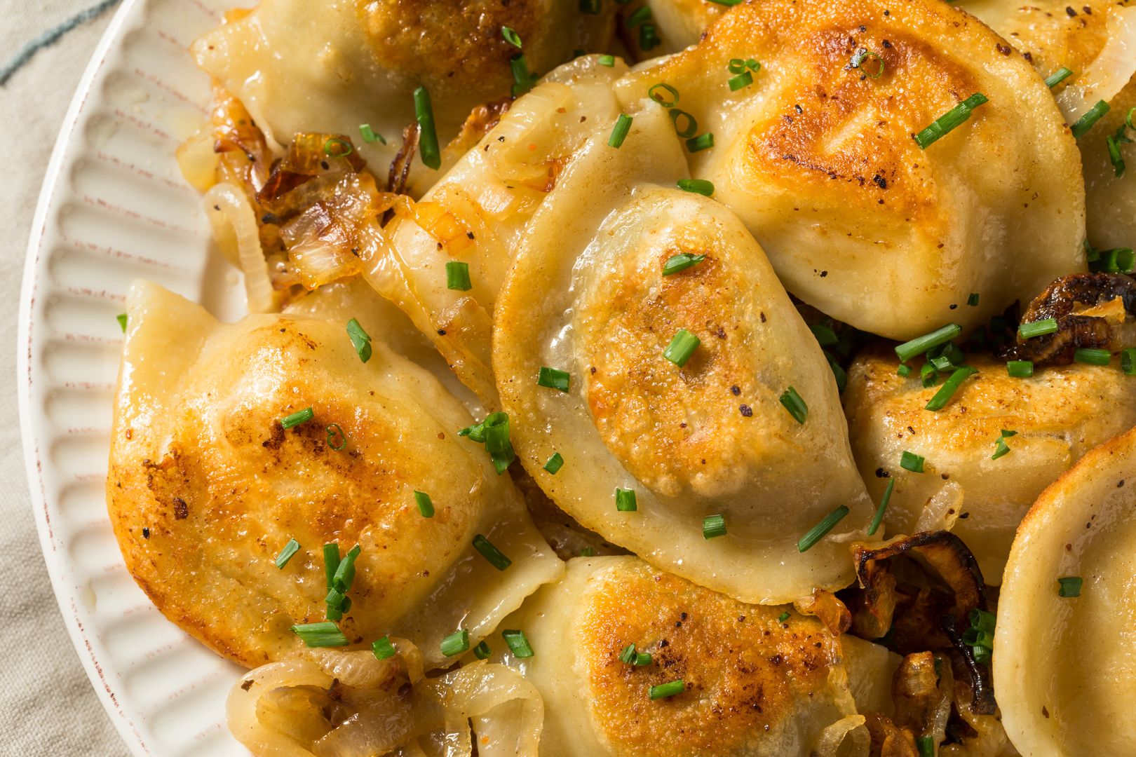 Homemade Polish Potato Pierogies  with Onion and Chives
background, boiled, cabbage, cheese, cooked, cooking, cuisine, delicious, dinner, dish, dough, dumpling, dumplings, eating, filled, flour, food, fry, gourmet, homemade, lunch, meal, meat, nutrition, onion, pierogi, pierogies, plate, polish, potato, pyrohy, russian, stuffed, table, traditional, ukrainian, background, boiled, cabbage, cheese, cooked, cooking, cuisine, delicious, dinner, dish, dough, dumpling, dumplings, eating, filled, flour, food, fry, gourmet, homemade, lunch, meal, meat, nutrition, onion, pierogi, pierogies, plate, polish, potato, pyrohy, russian, stuffed, table, traditional, ukrainian