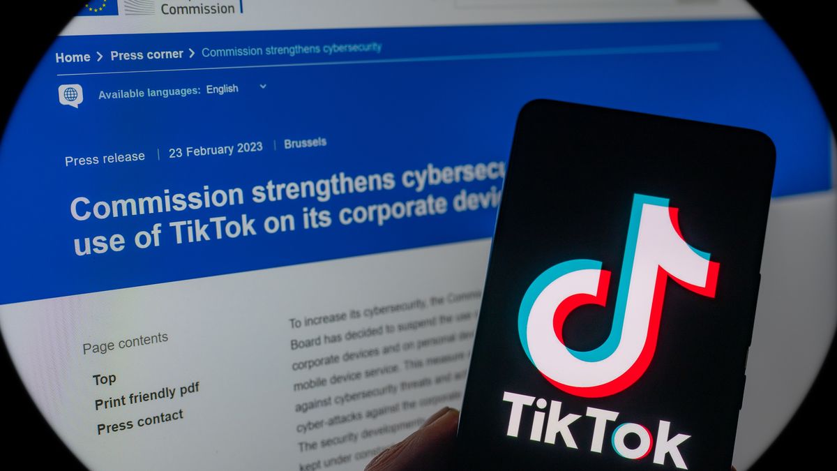 TikTok icon displayed on a phone screen with in the background European Union web page press release. seen in this photo illustration. on 23 February 2023 in Brussels, Belgium. (Photo illustration by Jonathan Raa/NurPhoto via Getty Images)