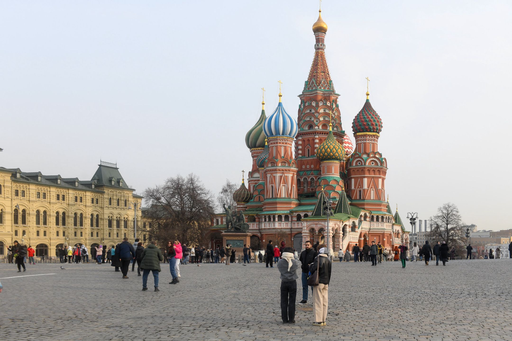 MOSCOW, RUSSIA - 2025/03/10: People stroll on red Square at the Kremlin near the Middle Shopping malls and the Cathedral of the Intercession of the Blessed Virgin Mary. (Photo by Daniel Felipe Kutepov/SOPA Images/LightRocket via Getty Images)