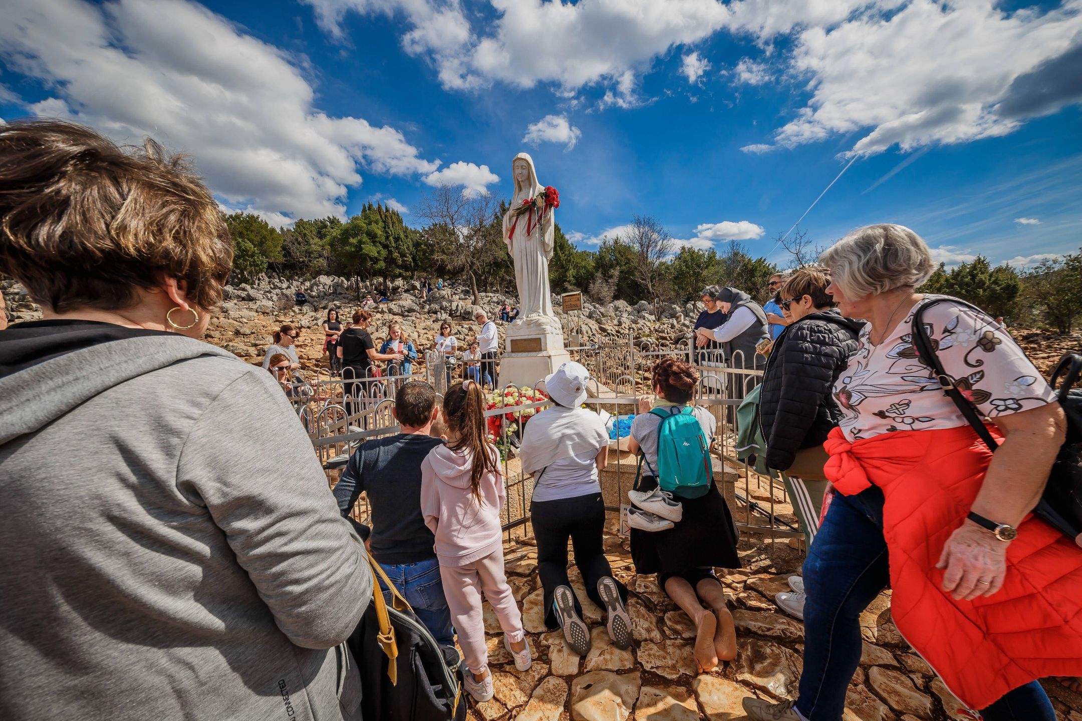 PXL_Medjugorje The Place of Faith
Statue of Virgin  Mary on the the Apparition Hill, in Medjugorie. Almost one million people visit Medjugorje each year, where the Virgin Mary is said to have appeared to six young villagers for the first time on June 24, 1981. For 30 years, the alleged phenomenon was ignored by Roman Catholic authorities until 2010, when Pope Benedict XVI issued an order to form an investigation team to search for the truth in case of Medjugorje sightings. in Medjugorje, Bosnia and Hezegovina on 26. March 2023. Photo: Zvonimir Barisin/PIXSELL 
Dostawca: PAP/PIXSELL
Zvonimir Barisin/PIXSELL
Medjugorje, lady, apparition, pilgrims, Bosnia and Herzegovina, tourism, religious tourism, The Virgin Mary, Catholics, aerial photography, aerial shot, aerial photography, bird view, religia