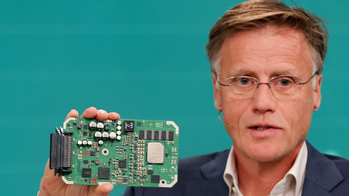 MUNICH, GERMANY - NOVEMBER 15: Jochen Hanebeck, CEO of Infineon AG, holds a model of an AURIX Microcontroller at the company's annual press conference on November 15, 2023 in Munich, Germany. Infineon is Germany's biggest manufacturer of semiconductors and is expanding its domestic production as Europe seeks to become less dependent on computer chip imports from Asia. (Photo by Leonhard Simon/Getty Images)