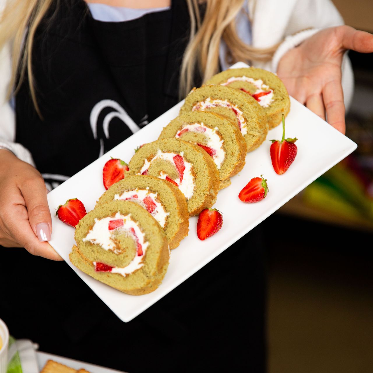 Green sponge cake roll with strawberries