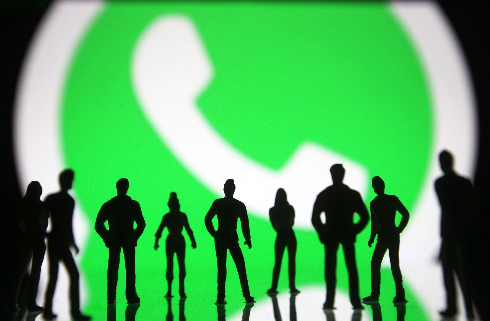 UKRAINE - 2021/01/09: In this photo illustration silhouettes of figured toy people seen in front of the WhatsApp logo.
In January 2021, WhatsApp announced a new Privacy Policy that will allow WhatsApp to share data with Facebook, and users will be to accept the new policy by 8 February 2021, or stop using the app, reportedly by media. (Photo Illustration by Pavlo Gonchar/SOPA Images/LightRocket via Getty Images)
