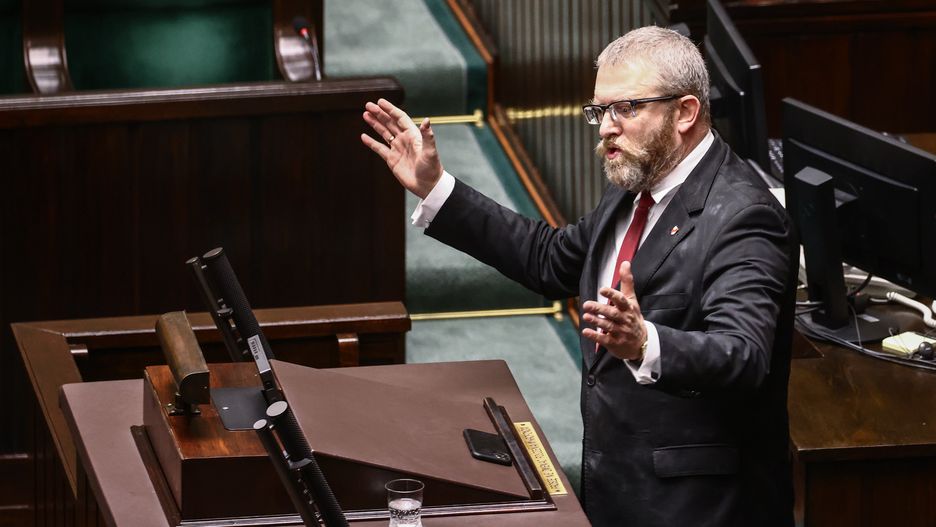 Grzegorz Braun, a member of the far-right Confederation party speaks in the parliament  after using a fire extinguisher to put out candles on a menorah that was lit during Hannukah celebration in the parliament building in Warsaw, Poland on December 12, 2023.  (Photo by Beata Zawrzel/NurPhoto via Getty Images)