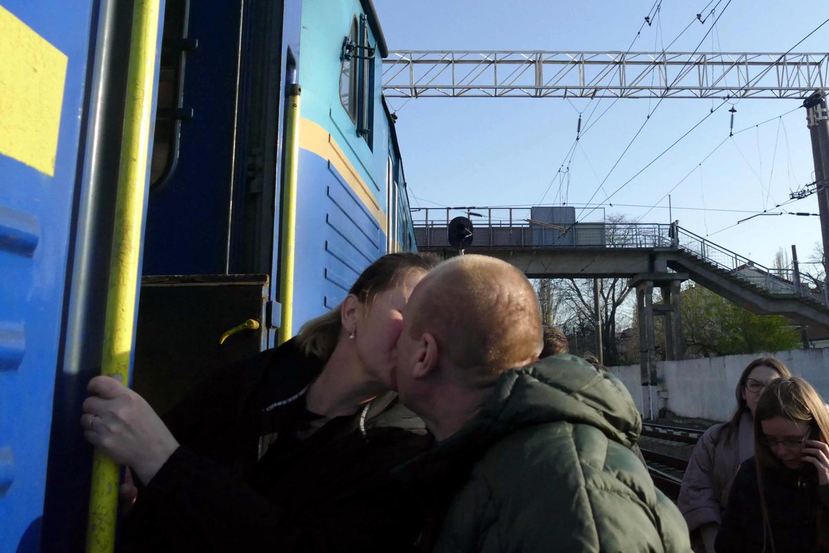 ODESA, UKRAINE - APRIL 25, 2022 - A man and a woman kiss goodbye before the departure of an evacuation train that will take people fleeing the Russian invasion to Przemysl, Poland, Odesa, southern Ukraine. (Photo credit should read Yulii Zozulia/ Ukrinform/Future Publishing via Getty Images)