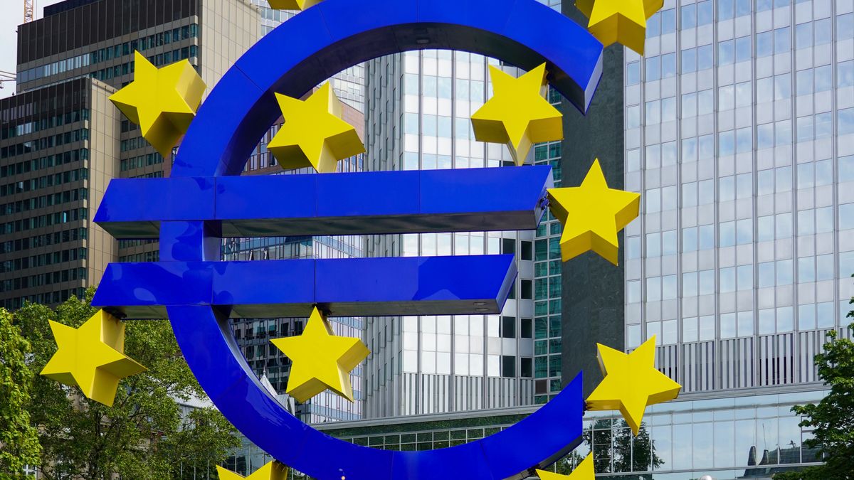 Visitors admire the monumental Euro sculpture by Ottmar Horl, located at Willy-Brandt-Platz in Frankfurt am Main, Germany, on August 15, 2023. The 14-meter-high, 50-tonne illuminated installation displays a striking blue Euro sign encircled by twelve yellow stars, symbolizing the unity of the European Union. Surrounded by modern architecture, the artwork is a landmark of Frankfurt's financial district, drawing attention from both locals and tourists. (Photo by Michael Nguyen/NurPhoto via Getty Images)