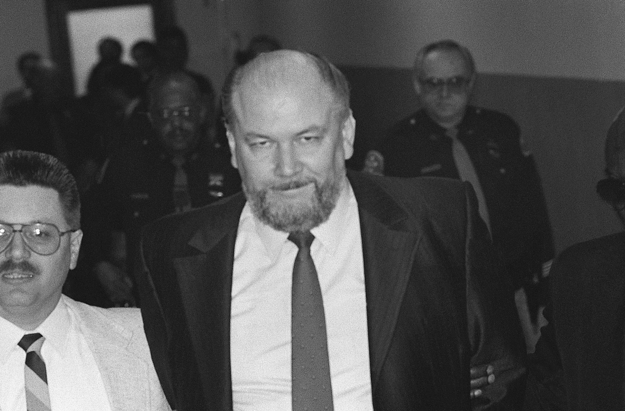 Murder Suspect Richard Kuklinski Enter Courtroom(Original Caption) 3/14/1988-Hackensack, New Jersey-: Richard Kuklinski, known as "The Iceman," enters the Bergen County Court where closing arguments are underway in his trial on charges that he murdered two associates.Bettmannlooking at camera:CB2, 1980s:CB1, murder:CB2, group of people:CB1, suspect:CB3, mid-adult man:CB2, head and shoulders:CB2, prominent persons:CB2, Caucasian ethnicity:CB2, police officer:CB2, law court:CB1, outdoors:CB1, American:CB2, courtroom:CB2, assassin:CB2, trial:CB1, town:CB2, Hackensack:CB2, Richard Kuklinski:CB3