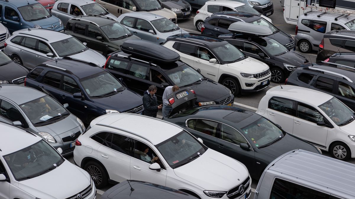 GENOA, ITALY - APRIL 23: Passengers stand next to their vehicles lined up waiting to board on the Italian shipping company Tirrenia’s Athara Ro-Ro/Passenger Ship (not i picture), berthed in the port on April 23, 2023 in Genoa, Italy. The Genoa Port is the busiest seaport of Italy, featuring an annual capacity of 4 million ferry and cruise passengers, 1.5 million cars and 250.000 trucks. (Photo by Emanuele Cremaschi/Getty Images)