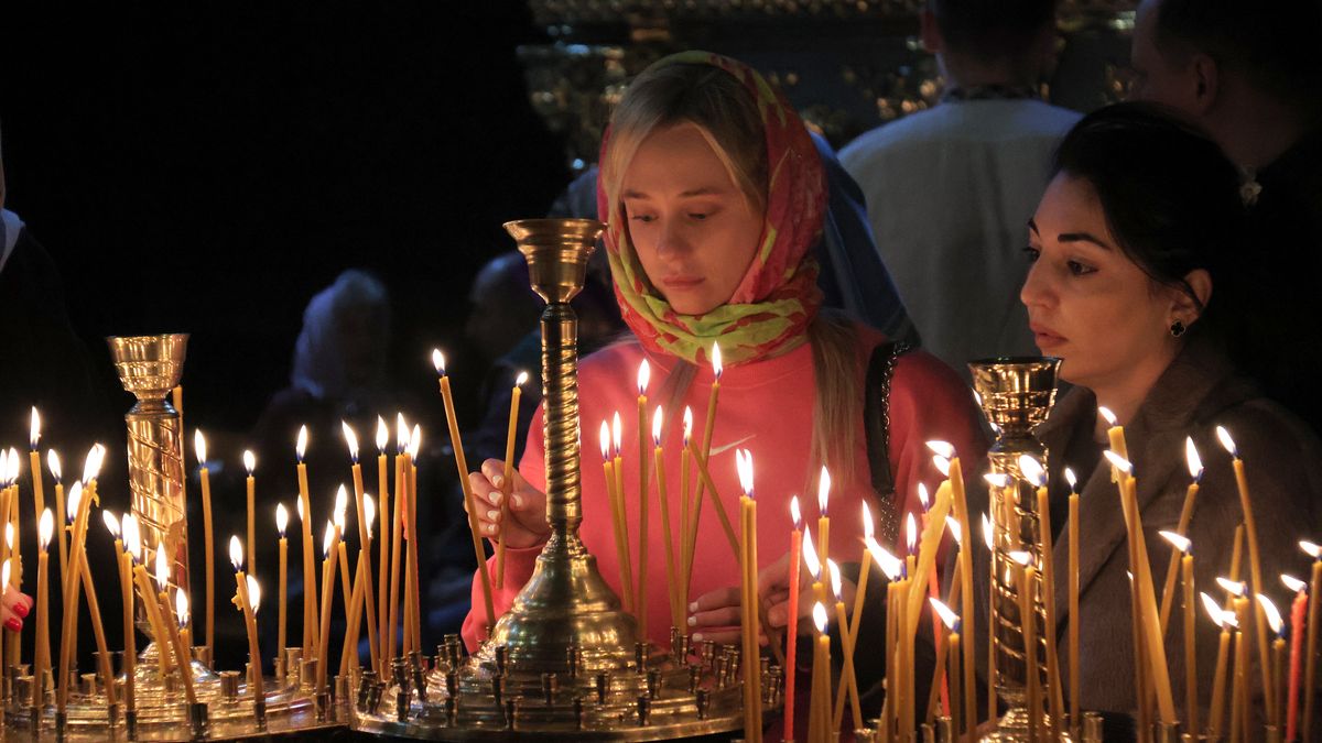 KYIV, UKRAINE - MAY 5, 2024 - Women place burning candles at St Michael's Golden-Domed Cathedral on Orthodox Easter, Kyiv.  (Photo credit should read Eugen Kotenko / Ukrinform/Future Publishing via Getty Images)
