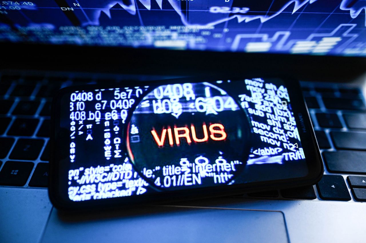 In this photo illustration a Virus symbol logo is displayed on a smartphone with stock market percentages in the background. (Photo Illustration by Omar Marques/SOPA Images/LightRocket via Getty Images)