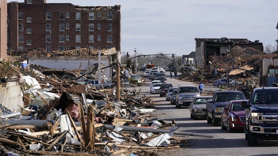TemporaryPeople survey damage from a tornado is seen in Mayfield, Ky., on Saturday, Dec. 11, 2021. Tornadoes and severe weather caused catastrophic damage across multiple states late Friday, killing several people overnight. (AP Photo/STFAP