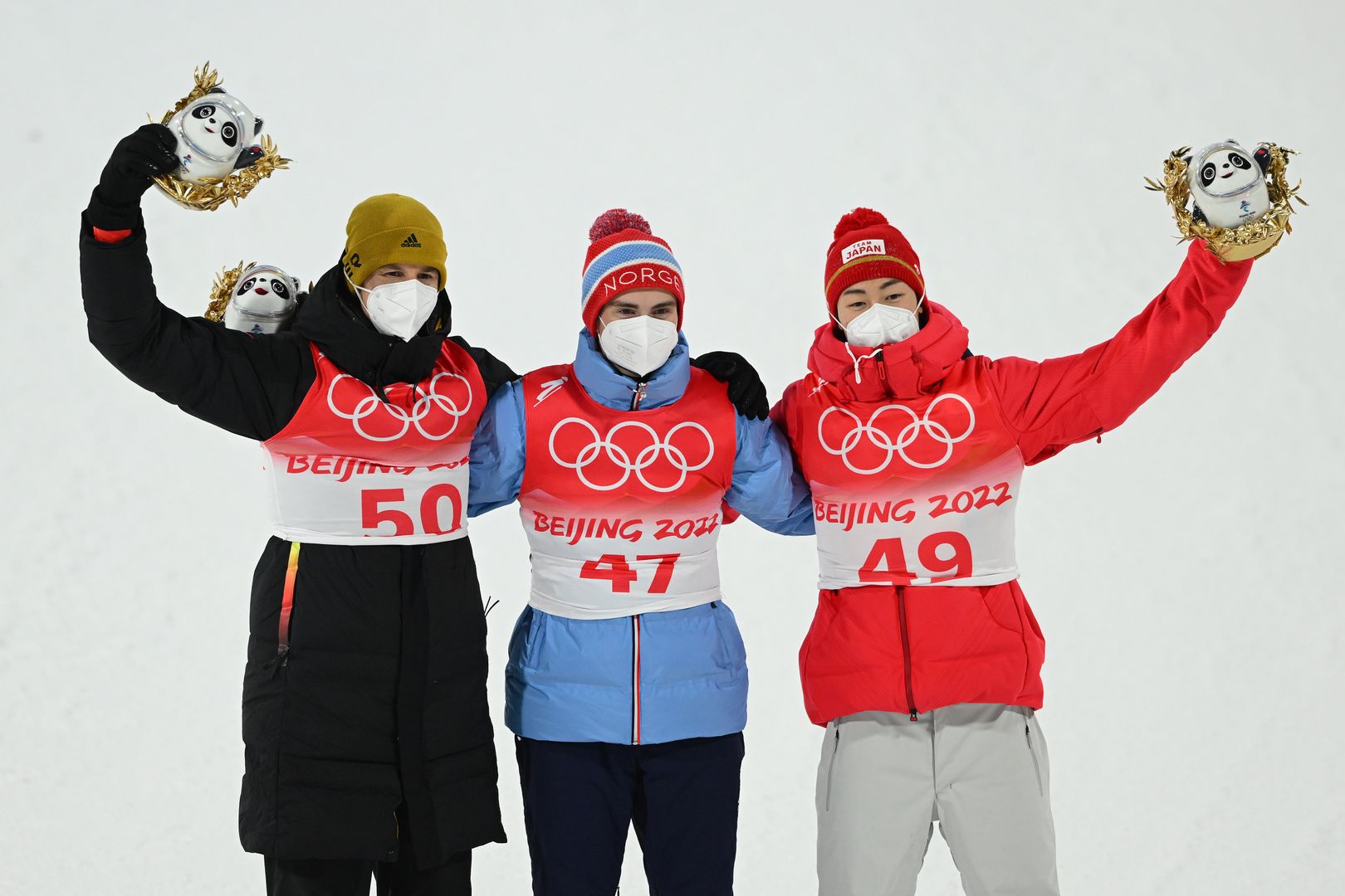 ZHANGJIAKOU, CHINA - FEBRUARY 12: Gold medal winner Marius Lindvik of Team Norway (C), Silver medal winner Ryoyu Kobayashi of Team Japan (R) and Bronze medal winner Karl Geiger of Team Germany (L) celebrate on the podium following the Men's Large Hill Individual Final Round on Day 8 of Beijing 2022 Winter Olympics at National Ski Jumping Centre on February 12, 2022 in Zhangjiakou, China. (Photo by Matthias Hangst/Getty Images)