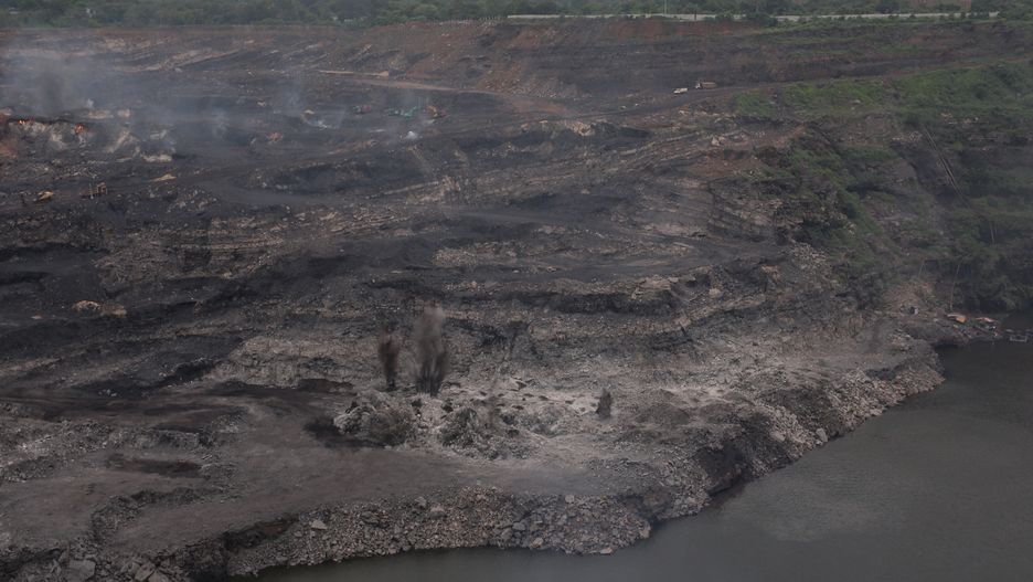 DHANBAD, INDIA - AUGUST 08: An aerial view of the blasting process of an open cast coal mine on August 08, 2025 in the outskirts of Dhanbad, India. Jharkhand stands at the forefront of India's coal production, anchoring the energy sector with its abundant reserves and strategic mining operations. The coalfields of Jharkhand play a pivotal role in powering the nation, supporting industries, providing employment, and contributing significantly to India's economic growth, which is underpinned by a transition to high-value manufacturing. (Photo by Ritesh Shukla/Getty Images)