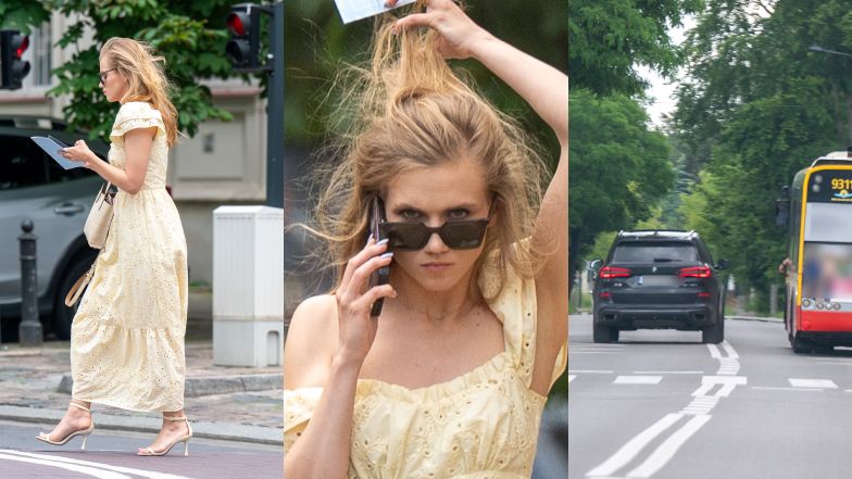 agnieszka kaczorowska szwendaは、電話で彼の鼻を持って、二重の連続でバスの前に彼の鼻を置いて街の周り