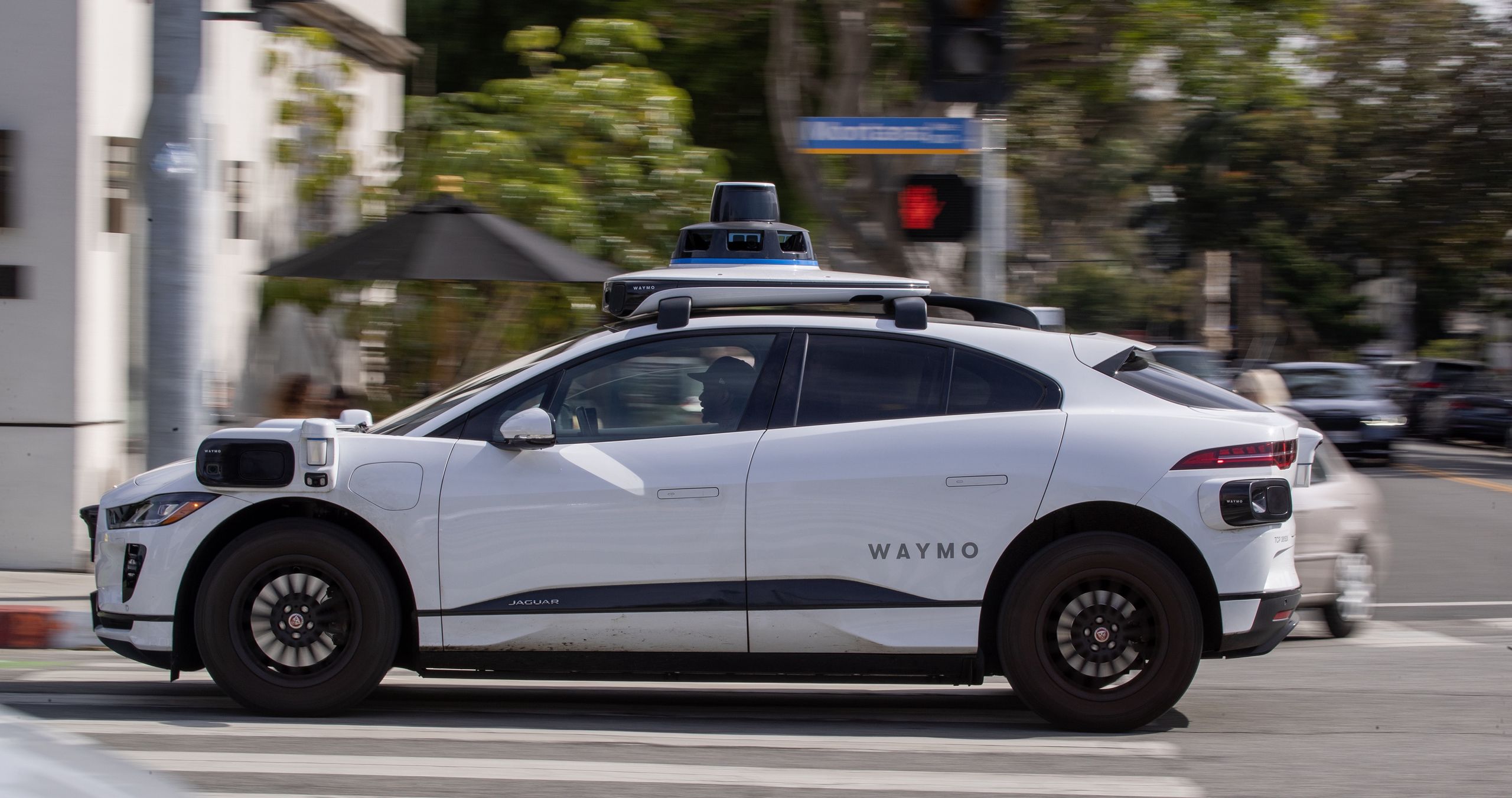 Santa Monica, CA - February 21: Passengers ride in an electric Jaguar I-Pace car outfitted with Waymo full self-driving technology in Santa Monica Tuesday, Feb. 21, 2023.  (Allen J. Schaben / Los Angeles Times via Getty Images)