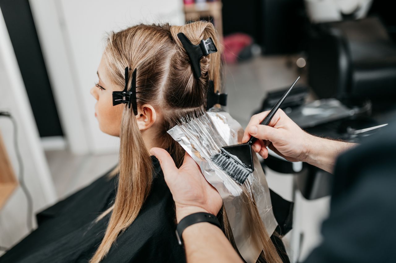 Dyeing hair to a mousey blonde colour.