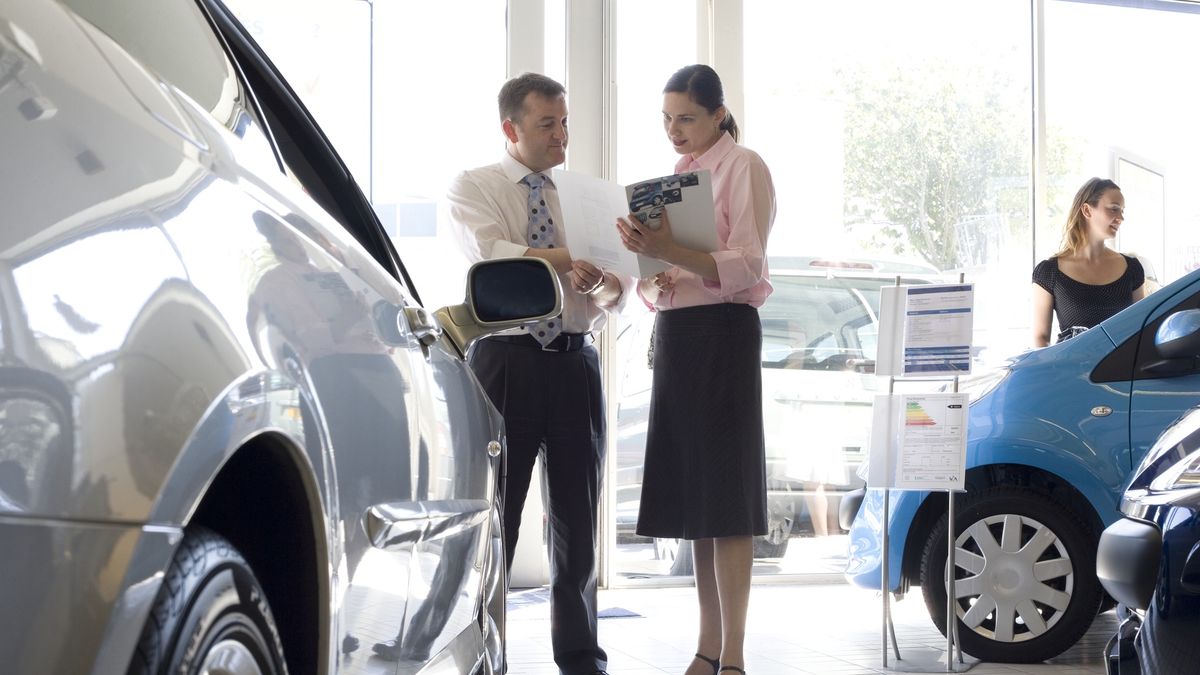 Woman talking to auto salesman in showroom
Plymouth, Devon, UK
Peter Cade
woman buying car looking shopping