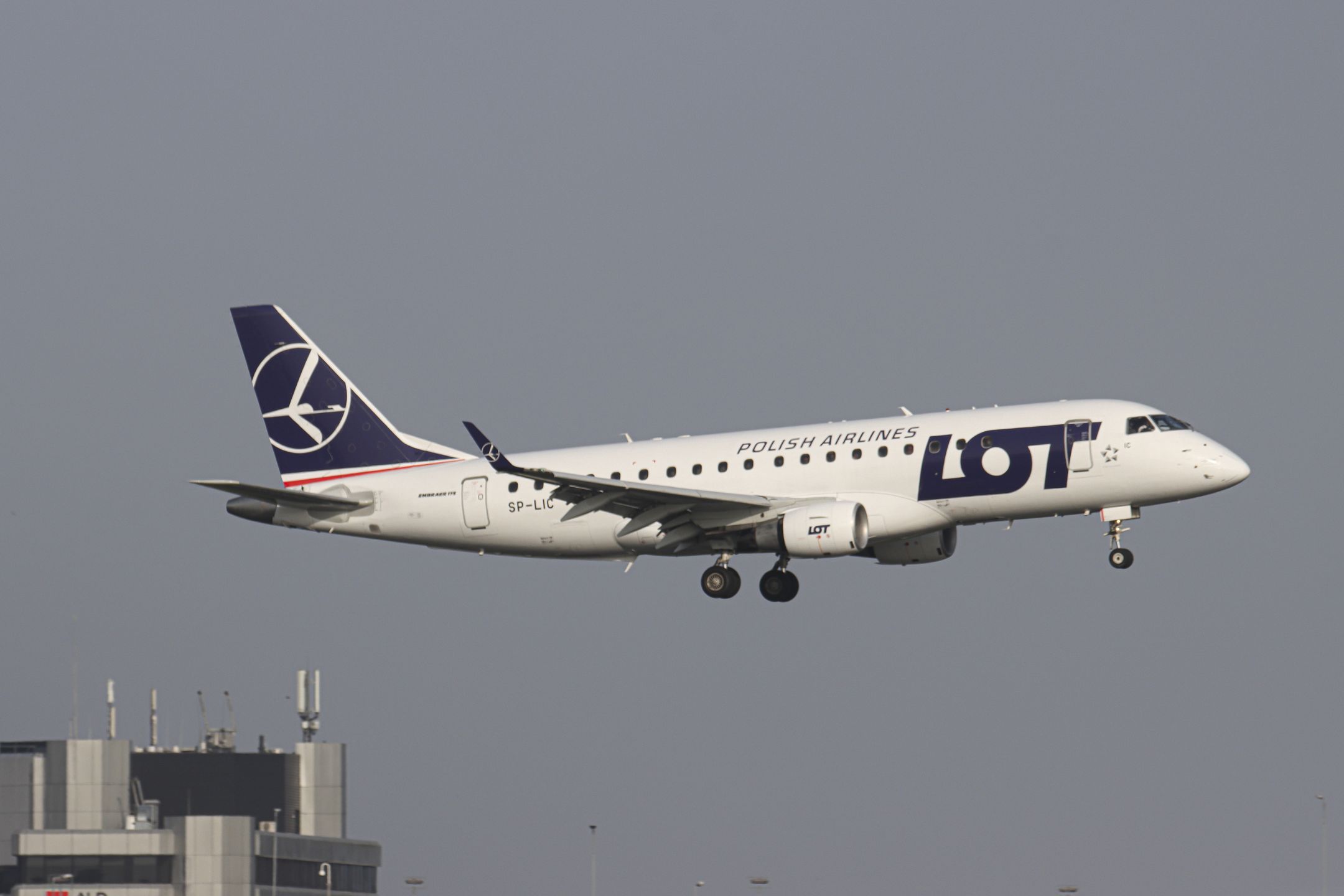 Polish Airlines LOT Embraer ERJ-175 aircraft as seen on final approach flying, arriving for landing at the runway of Amsterdam Schiphol AMS EHAM Airport. The Brazilian-made narrow body airplane is a regional Embraer ERJ 175 with the registration SP-LIC. LOT Polish Airlines, legally incorporated as Polskie Linie Lotnicze LOT S.A. is the flag carrier airline of Poland and a member of the Star Alliance aviation group. The aviation industry and passenger traffic are phasing a difficult period with the Covid-19 coronavirus pandemic having a negative impact on the travel business industry with fears of the deteriorating situation due to the new Omicron variant mutation. Amsterdam, the Netherlands on April 1, 2021 (Photo by Nicolas Economou/NurPhoto via Getty Images)