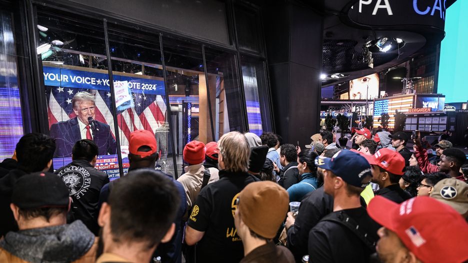 NEW YORK, USA - NOVEMBER 06: Residents in New York watch Donald Trump's speech on a screen as the vote counting continued in the election between Democratic Party candidate Kamala Harris and Republican Party candidate Donald Trump on November 06, 2024. (Photo by Fatih Aktas/Anadolu via Getty Images)