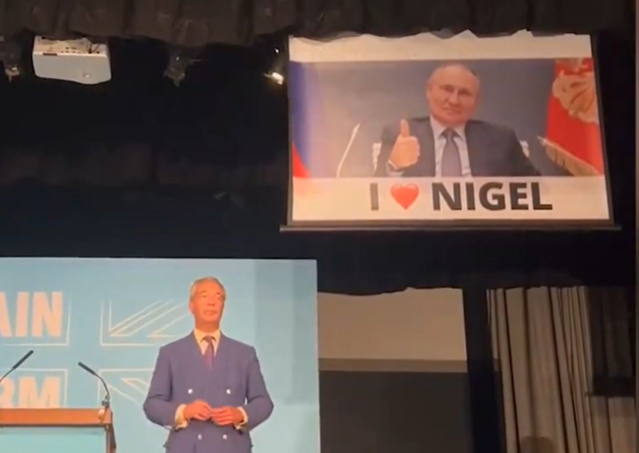 Scandal in the United Kingdom. Banner with Putin at Farage's rally