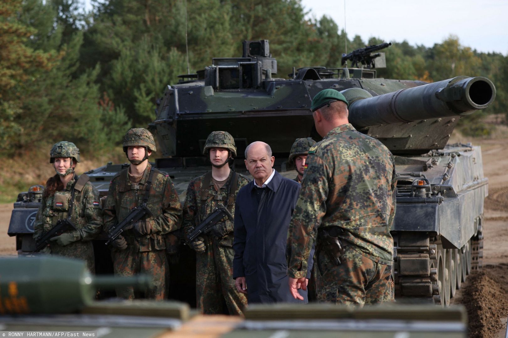 Temporary
German Chancellor Olaf Scholz (C) listens in front of a Leopard 2 main battle tank of the German armed forces Bundeswehr during a visit of German Bundeswehr's troops during a training exercise at the military ground in Ostenholz, northern Germany, on October 17, 2022. (Photo by Ronny HARTMANN / AFP)
RONNY HARTMANN