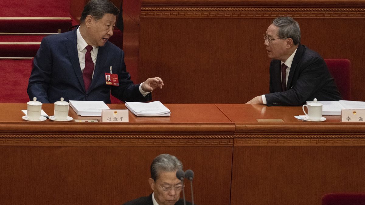 BEIJING, CHINA - MARCH 5: Chinese President Xi Jinping (L) and Premier Li Qiang speak after Li's speech at the opening session of the National People's Congress at the Great Hall of the People on March 5, 2026 in Beijing, China. China's annual political gatherings, which includes the important National People's Congress (NPC), and is known as the Two Sessions, convenes leaders and lawmakers to set the government's agenda for domestic economic and social development for the year. The meetings are expected to close by March 12th. (Photo by Kevin Frayer/Getty Images)