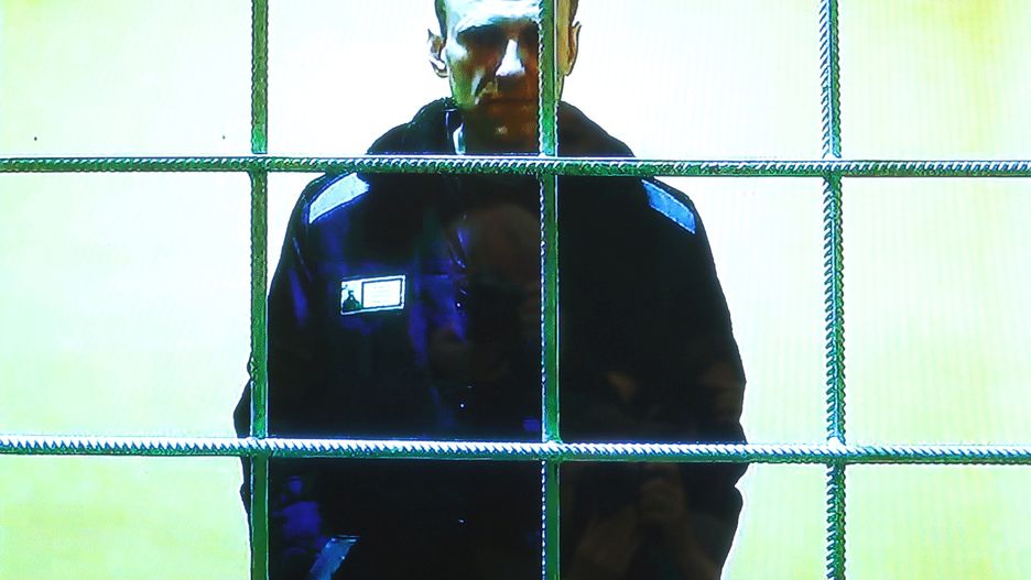 Russian opposition leader Alexei Navalny is seen on a screen via video link from the IK-2 corrective penal colony in Pokrov before a court hearing to consider an appeal against his prison sentence, in Moscow, Russia May 17, 2022.