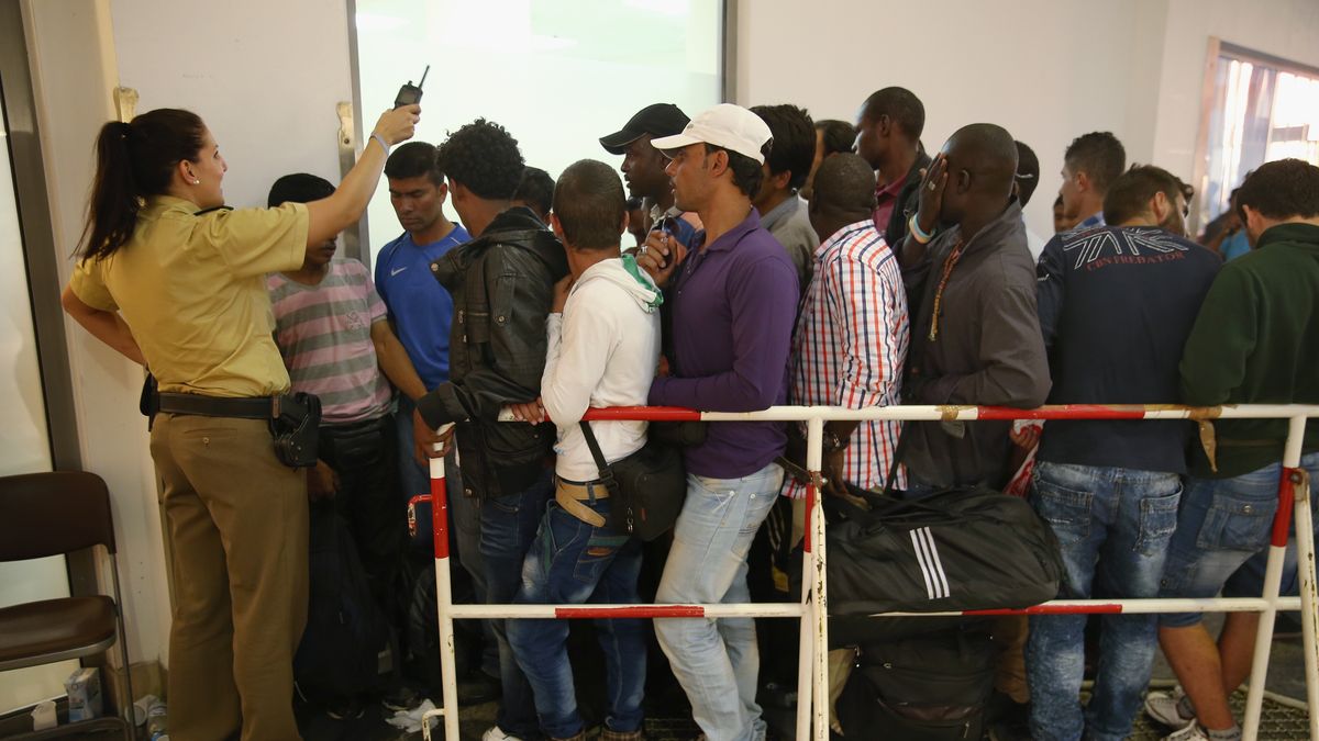 Migrants Arrive Daily In Southern Germany
MUNICH, GERMANY - AUGUST 29:  A policewoman urges migrants in a holding who had arrived by train at Munich Hauptbahnhof main railway station and were detained by police because they had no passports to move back before registration on August 29, 2015 in Munich, Germany. According to police hundreds of migrants are arriving in southern Germany daily, either via people smugglers from Hungary along the A3 highway or via trains coming from Italy. Germany is expecting to receive 800,000 asylum-seeking migrants this year and is struggling to cope with the record number.  (Photo by Sean Gallup/Getty Images)
Sean Gallup
refugees