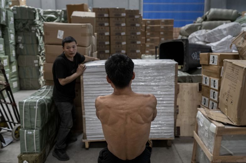 YIWU, CHINA - APRIL 29: Workers move goods for export before loading them on a container at a logistics hub on April 29, 2025 in Yiwu, Zhejiang Province, China. The Yiwu area is home to thousands of China's small commodities companies, many of which in recent years due to trade tensions with the United States have looked to the Middle East, Africa, Europe and South America for new business. After President Trump put tariffs as high as 145 percent on Chinese goods, many producers saw orders from American clients cancelled or at least temporarily put on hold. (Photo by Kevin Frayer/Getty Images)