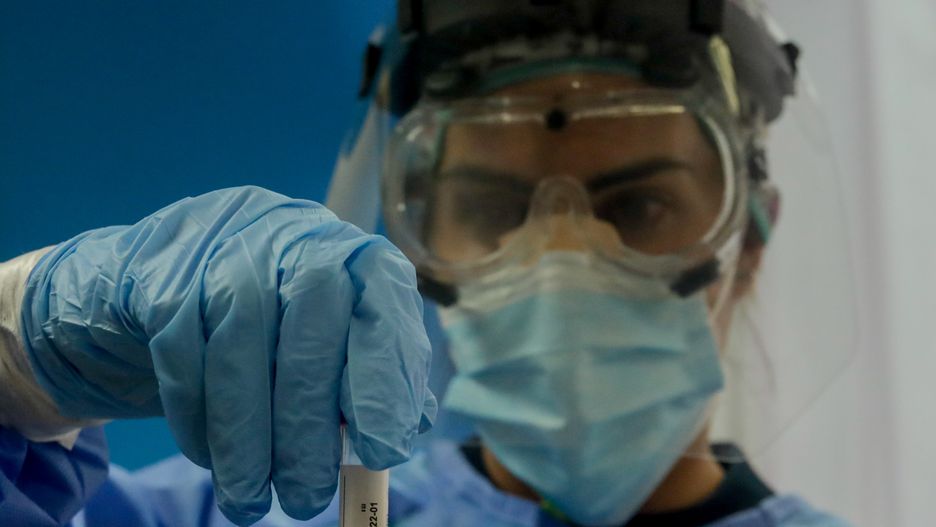 MADRID, SPAIN - AUGUST 27: A health worker holds a test tube with a PCR test on the device installed at El Arroyo Specialty Center, on August 27, 2020 in Fuenlabrada, Madrid, Spain. (Photo by Ricardo Rubio/Europa Press via Getty Images)