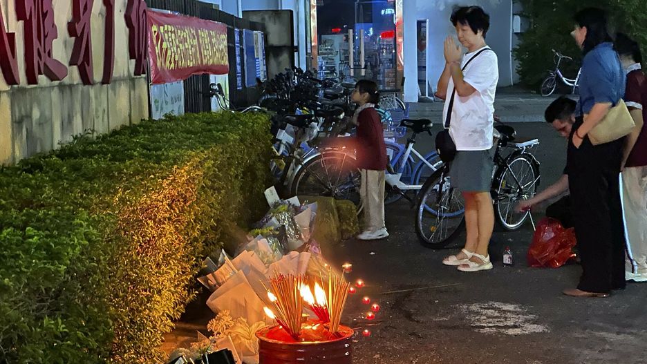 Temporary
A woman prays after incense were offered near flowers places outside the "Zhuhai People's Fitness Plaza" where a man deliberately rammed his car into people exercising at the sports center, killing some and injuring others in Zhuhai in southern China's Guangdong province on Tuesday, Nov. 12, 2024. (AP Photo/Ng Han Guan)
Ng Han Guan