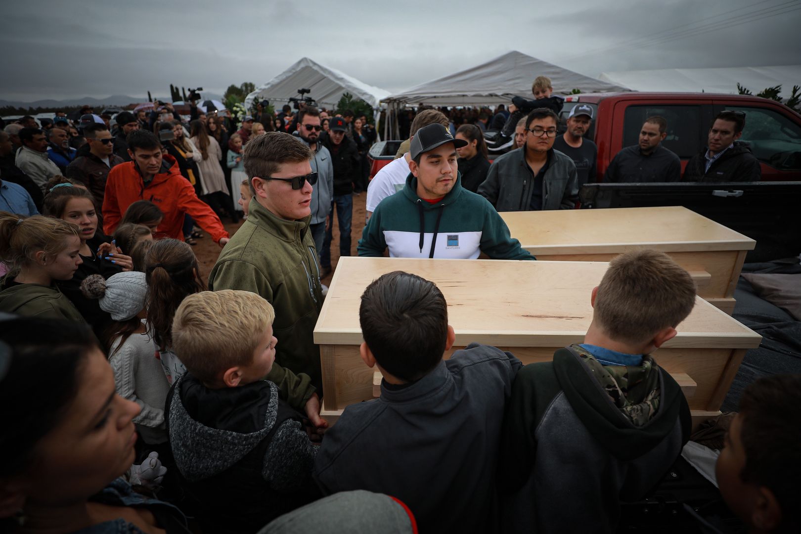 LE BARÓN, MEXICO - NOVEMBER 08: Members of local Mormon communities and relatives of the extended Le Baron family carry the caskets of Rhonita Maria Miller and their sons on November 08, 2019 in Le Barón, Mexico. Three families were traveling in separate SUVs from their homes in La Mora in Sonora to farm town Le Barón in Cihuahua on Monday when they were ambushed in two separate attacks by cartel gunmen hidden in the mountains along the dirt road. As a result, three women and six children died. All family members had dual Mexican-American citizenship and belonged to a Mormon offshoot group not affiliated with The Church of Jesus Christ of Latter-day Saints. Via Twitter, President Donald Trump said on Tuesday that U.S stands ready to help Mexico in the war against drug cartels. (Photo by Manuel Velasquez/Getty Images)