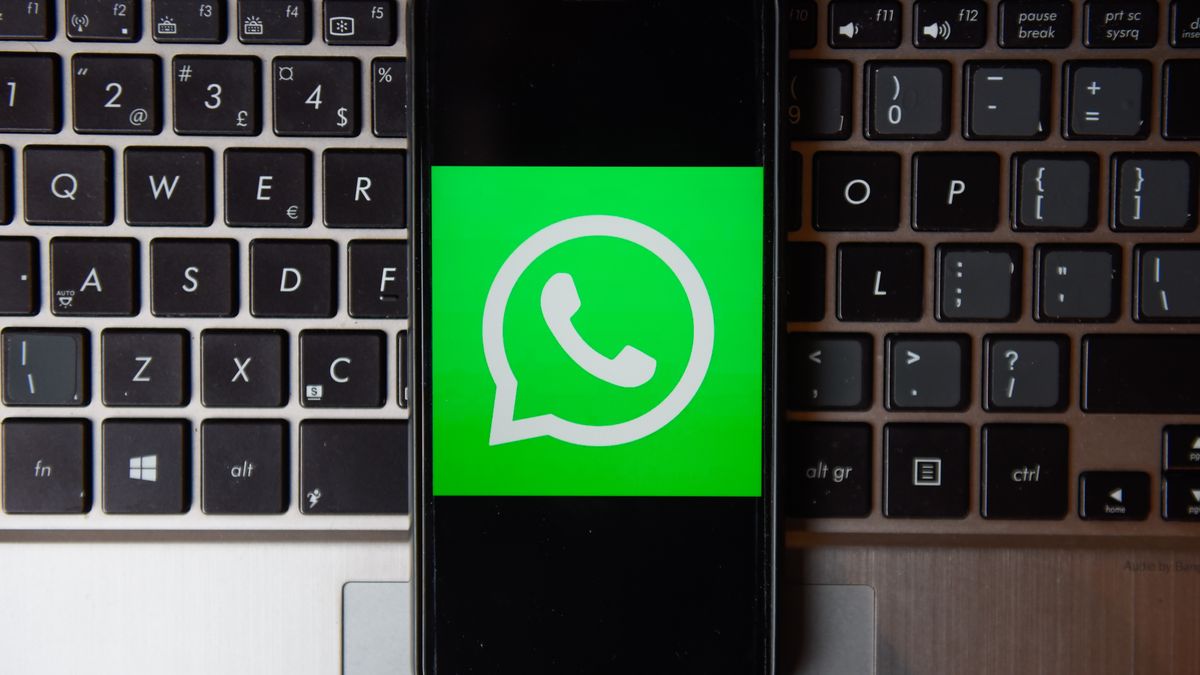 POLAND - 2020/10/21: In this photo illustration a WhatsApp logo seen displayed on a smartphone with a laptop keyboard on the background. (Photo Illustration by Omar Marques/SOPA Images/LightRocket via Getty Images)