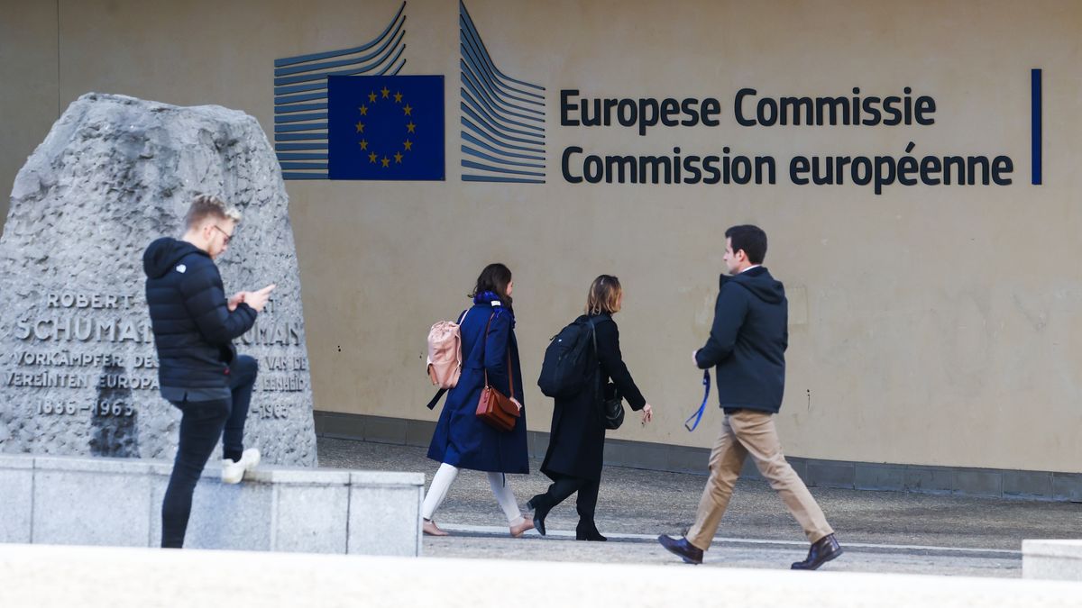 People pass by the European Comission sign on the Berlaymont building in Brussels, Belgium on October 11, 2022. (Photo by Jakub Porzycki/NurPhoto via Getty Images)