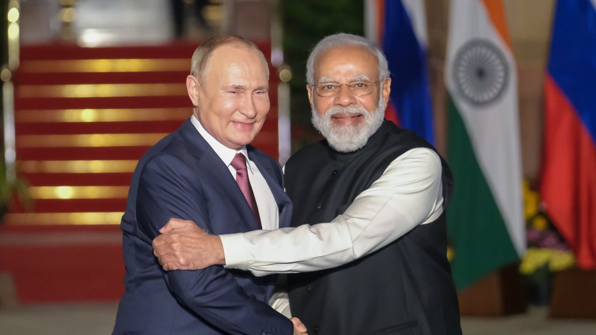 Narendra Modi, India's prime minister, right, and Vladimir Putin, Russia's president, pose for photographs as Putin arrives at Hyderabad House in New Delhi, India, on Monday, Dec. 6, 2021. Putin visits New Delhi as billions of dollars of Russian weaponry flow into India that would normally attract U.S. sanctions. Eager to draw India into its efforts to contain China, the U.S. may look away this time. Photographer: T. Narayan/Bloomberg via Getty Images